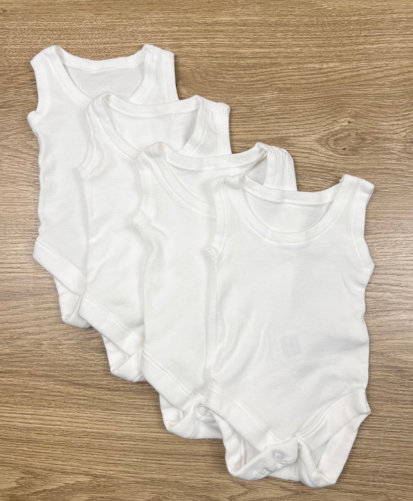 M&S 4 Pack of White Sleeveless Bodysuits - Size 00000